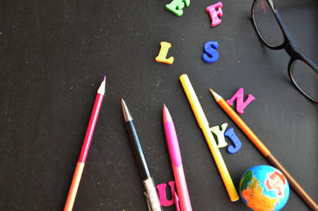 School supplies on blackboard background ready for your design top view copy space. back to school.の写真素材