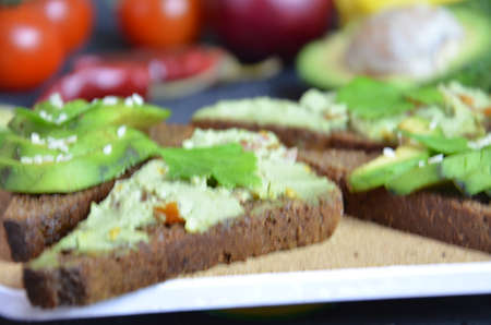 Guacamole with bread and avocado Sandwich with avocado and guacamole. Black cereal bread....
