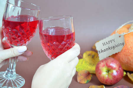 Thanksgiving Day. Pumpkin, pumpkin with autumn leaves and apples. Autumn harvest on a brown background. Happy Thanksgiving Lettering set table for celebration. fork and knife still life with bottle glass of red wine/の写真素材
