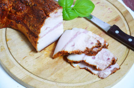 Assortment of salami and snacks. Sausage Fouet, sausages, salami, paperoni. On a black and wooden background. Top view. Free space for your textの写真素材