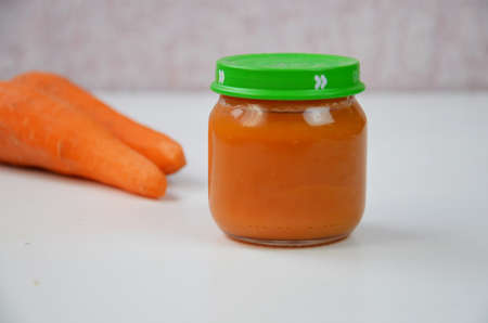 baby food, baby mashed in a glass jar, sliced carrotの写真素材