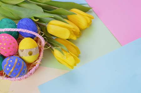 Easter eggs lying in a basket. Inscription Happy Easter. Space for text. Selected focus.の写真素材