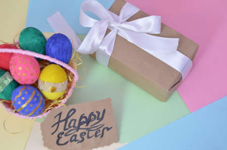 Easter, Easter egg color vibrant, spring Orthodox holiday. colorful decorated eggs in a pink basket on a background of different colorsの写真素材