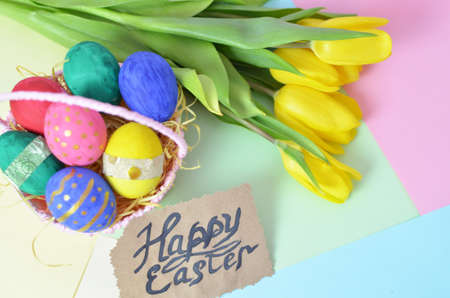Easter eggs lying in a basket. Inscription Happy Easter. Space for text. Selected focus.