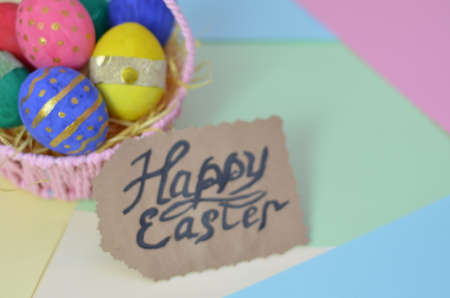Easter, Easter egg color vibrant, spring Orthodox holiday. colorful decorated eggs in a pink basket on a background of different colorsの写真素材