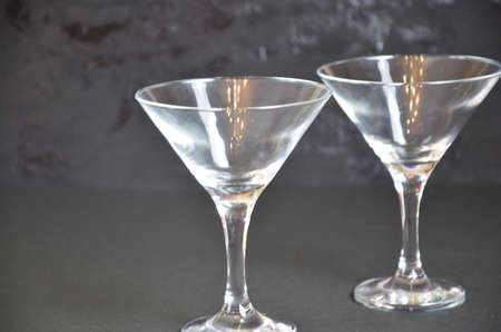 two empty glasses for making margarita cocktails with lime on a black background Margarita cocktails shot on a bar counter in a nightclub.の写真素材