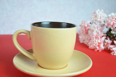beige cup cappuccino beautiful white-pink aster flowers on a red background. good morning. greeting card. view from above. save space cookies macarune breakfast on Mothers day or Womens day.の写真素材