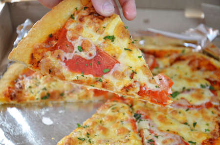 Pizza Margherita in the box, top view. Pizza Margarita with Tomatoes, Basil and Mozzarella Cheese close up. textureの写真素材