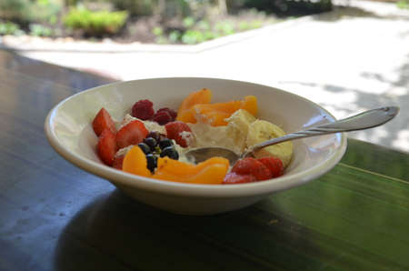 Healthy breakfast or snack curd with fruit and nuts. The concept of nutrition for weight loss. Keto breakfast. Keto lunch idea. cottage cheese or yogurt with berries on a window cup of coffee or tea.の写真素材