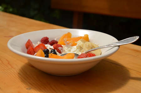 Healthy breakfast or snack curd with fruit and nuts. The concept of nutrition for weight loss. Keto breakfast. Keto lunch idea. cottage cheese or yogurt with berries on a window cup of coffee or tea.の写真素材