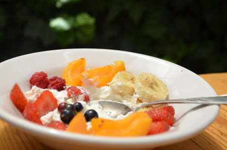 Healthy breakfast or snack curd with fruit and nuts. The concept of nutrition for weight loss. Keto breakfast. Keto lunch idea. cottage cheese or yogurt with berries on a window cup of coffee or tea.の写真素材