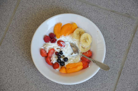 Healthy breakfast or snack curd with fruit and nuts. The concept of nutrition for weight loss. Keto breakfast. Keto lunch idea. cottage cheese or yogurt with berries on a window cup of coffee or tea.の写真素材