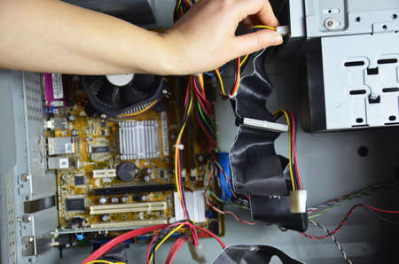 close-up on the hands of the technician repairing a computerの写真素材