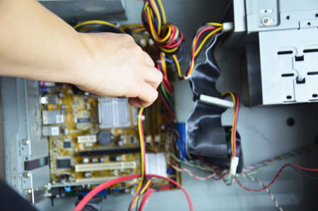 close-up on the hands of the technician repairing a computerの写真素材
