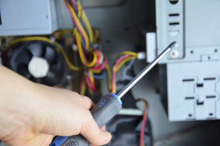 close-up on the hands of the technician repairing a computerの写真素材