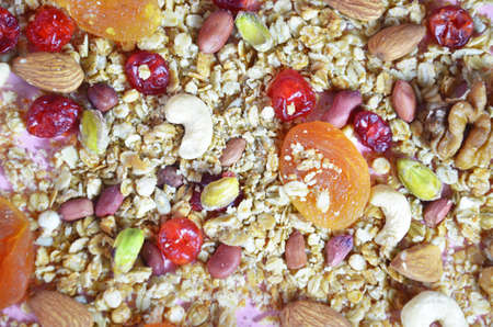 Background, texture of cereals, grains, granola, dried fruits, berries,. Homemade gluten free granola bars and mixed nuts, seeds, dried fruits. Copy space background.Top view. fitness bar, diet concept.の写真素材