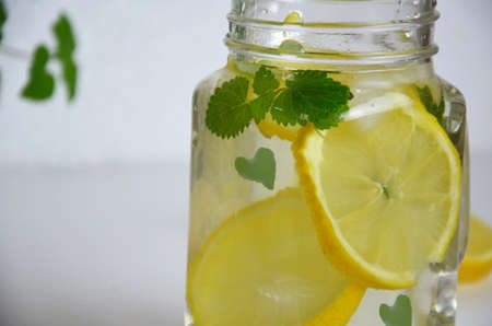 Glass of soda drink with lemon slices and mint isolated on white background. From top view. glass of lemon ice tea or detox water. health care fitness diet concept. lemonade or mojito cocktail.の写真素材