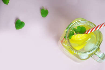 Glass of soda drink with lemon slices and mint isolated on white background. From top view. glass of lemon ice tea or detox water. health care fitness diet concept. lemonade or mojito cocktail.の写真素材