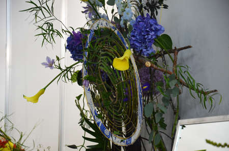 Floral shop concept Florist creates flower in a wicker basket. Beautiful bouquet mixed flowers. fresh bunch. Flowers delivery. Colorful bouquet of different orchids, roses, freesia eucalyptus leavesの写真素材