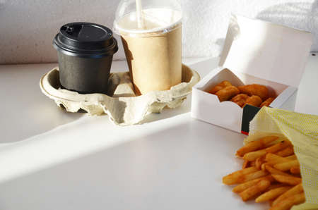 Yummy French fries, chicken Nuggets, , milkshake, sauce, latte and espresso. paper bag, white...