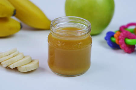Baby food, banana mashed potatoes and bananas on a white background it is isolated.の写真素材