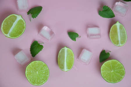 Mint, lime, ice, ingredients and bar utensils for making mojito cocktail on pink background. top view. to make a drink of lemonade, cold iced tea, a cocktail, mojito, detox. Texture Patternの写真素材