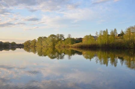 Beautiful colorful sunset over Lake in the forest or park with tree.の写真素材