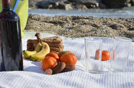 A party on the beach at sunset with wine. Romantic day evening in the summer by the sea. Picnic. copy space,の写真素材