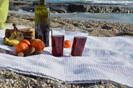 A party on the beach at sunset with wine. Romantic day evening in the summer by the sea. Picnic. copy space,の写真素材