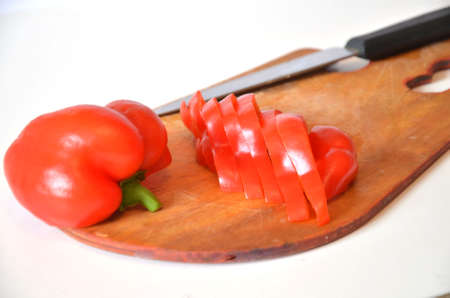 Sliced red sweet pepper on a cutting boardの写真素材