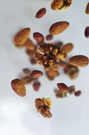 Nuts in the air on a white background, flying nuts. Healthy Brain Food, Diet, Protein, Almonds, walnuts and hazelnuts peanutの写真素材