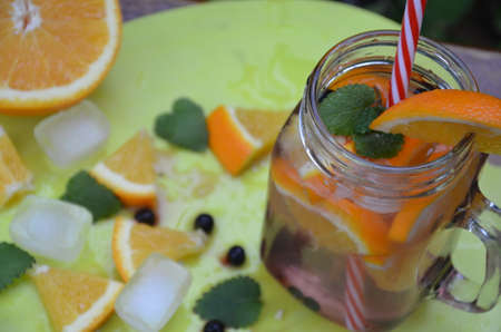 Infused detox water with orange, blueberry and mint. Ice cold summer cocktail or lemonade in glass mason jar, diet, body cleansing, healthy lifestyleの写真素材