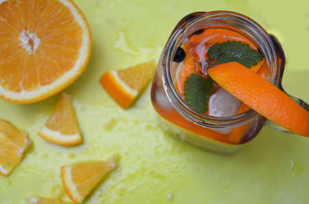 Infused detox water with orange, blueberry and mint. Ice cold summer cocktail or lemonade in glass mason jar, diet, body cleansing, healthy lifestyleの写真素材
