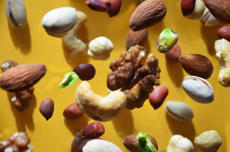 Nuts in the air on a yellow background, flying nuts. Healthy Brain Food, Diet, Protein, Almonds,...