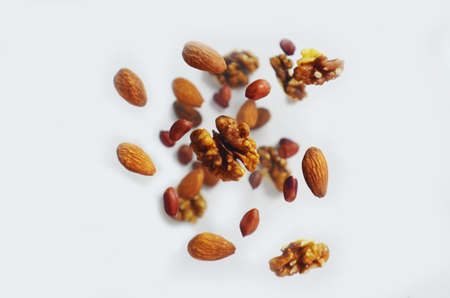 Nuts in the air on a white background, flying nuts. Healthy Brain Food, Diet, Protein, Almonds, walnuts and hazelnuts peanutの写真素材