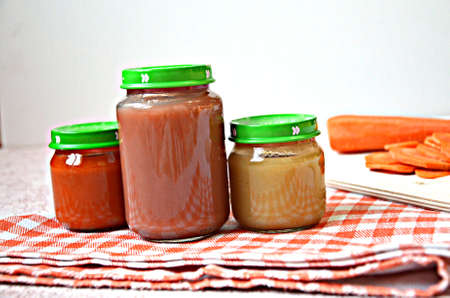 baby food, baby mashed in a glass jar, sliced carrotの写真素材