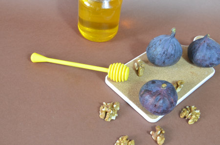ripe figs with honey and walnuts on a brown background, ingredients for a healthy breakfast, no sugar, diet. Healthy breakfast of superfoods, quinoa, honey, nuts, figs, coffee. Top viewの写真素材
