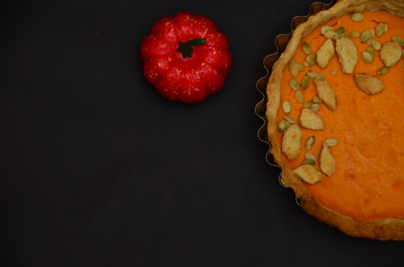 Fresh Homemade Pumpkin Pie made for Thanksgiving. on a black background. celebrating a holiday in autumn or winter. homemade bakingの写真素材