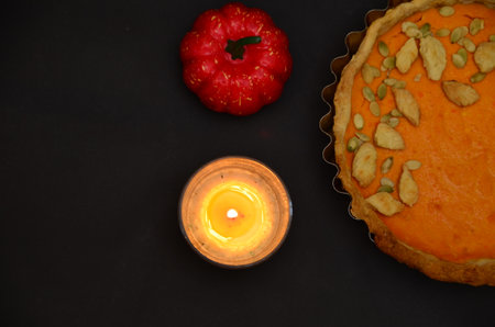 Fresh Homemade Pumpkin Pie made for Thanksgiving. on a black background. celebrating a holiday in autumn or winter. homemade bakingの写真素材