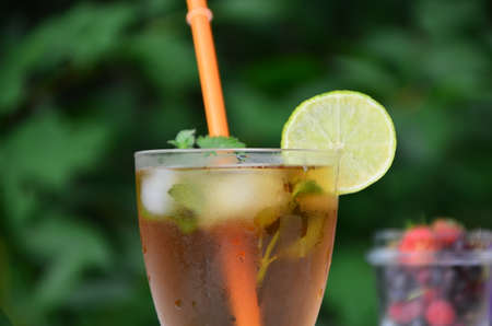 summer drink, tea with wild berries, lime, raspberries and blueberries, summer vacation, vacations. Raspberry mojito cocktail with lime, mint and ice, cold, iced refreshing drink or beverage.の写真素材