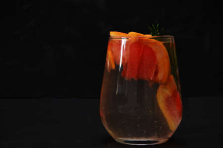 Grapefruit and rosemary gin cocktail or margarita, refreshing drink with ice on black background.の写真素材