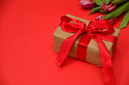 mother's day, woman's day. tulips ,presents on wooden white background, greeting card with the inscription happy mother's day, heartsの写真素材