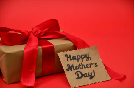 mother's day, woman's day. tulips ,presents on wooden white background, greeting card with the inscription happy mother's day, heartsの写真素材