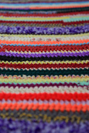 Knitted fabric from varicoloured woolen filaments by CU. At viewing creates illusion of a defocusing of sightの写真素材