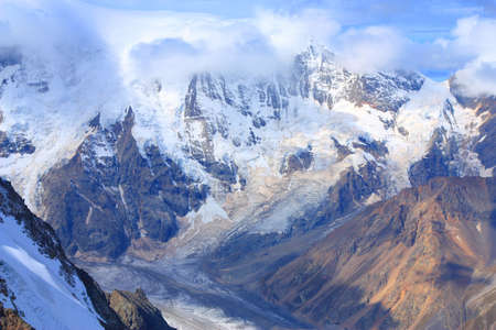 Clouds rolling over the mountains down to the valley.  Bezengy edge. Caucasusの写真素材