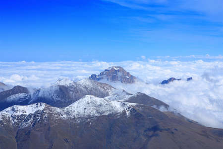 View from the top. clouds and other peaks remained far belowの写真素材