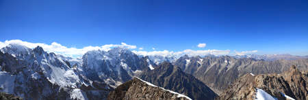 Panoramic view of the highest part of the main Caucasian ridge. From left to right tops are visible: Koshtan-tau (5150), Mizhirgi (5109), Dyh-tau 5206ï¿½), Gestola (4860ï¿½) and in the distance it is possible to see Elbrus (the highest mount in Europe, 56の写真素材