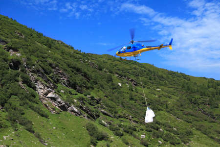 movement of goods in the mountains by helicopterの写真素材