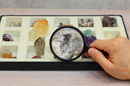 hand with lensbox and gems collectionの写真素材