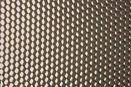 Black metal honeycombs on light background